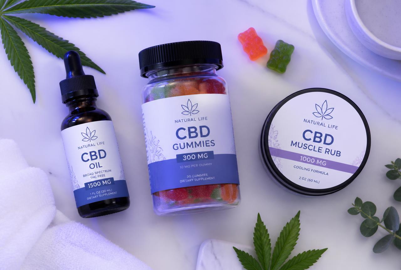 Velunis CBD oil, gummies and muscle rub balm laid out together